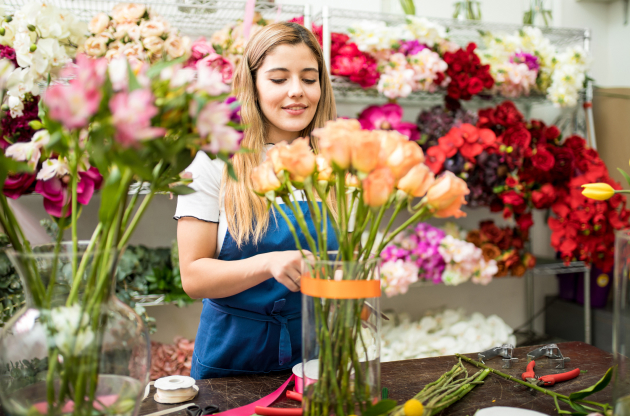 Florist arranging a bouquet in a flower shop.